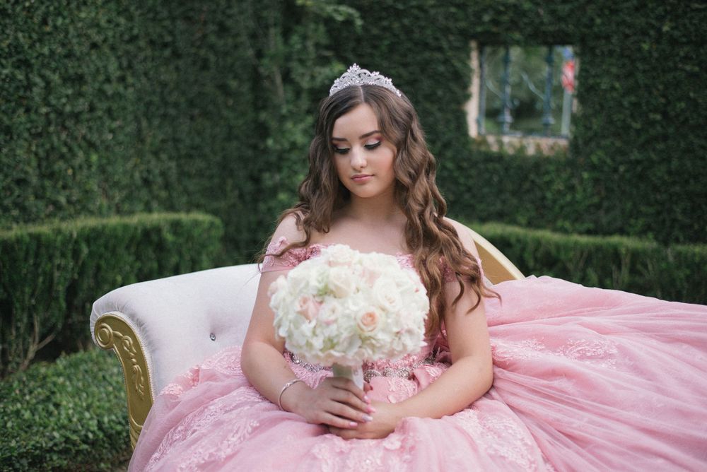 girl looking down at her bouquet. Casa Polonia. Weslaco, Texas. Wedding photography