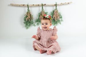 boho first birthday shoot.  Pale pink boho dress photoshoot with branches and greenery