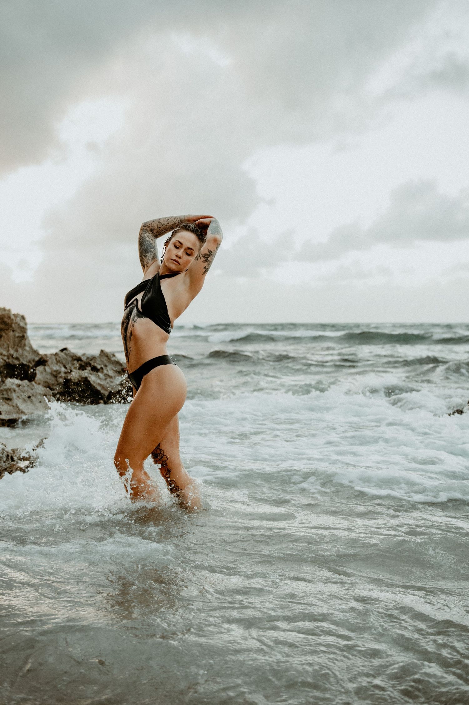 Outdoor boudoir portrait of woman embracing natural light and scenery