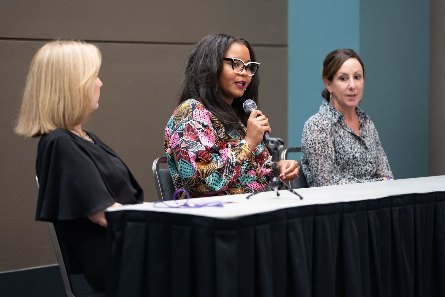 Diverse group of business experts engrossed in a panel discussion at a corporate event