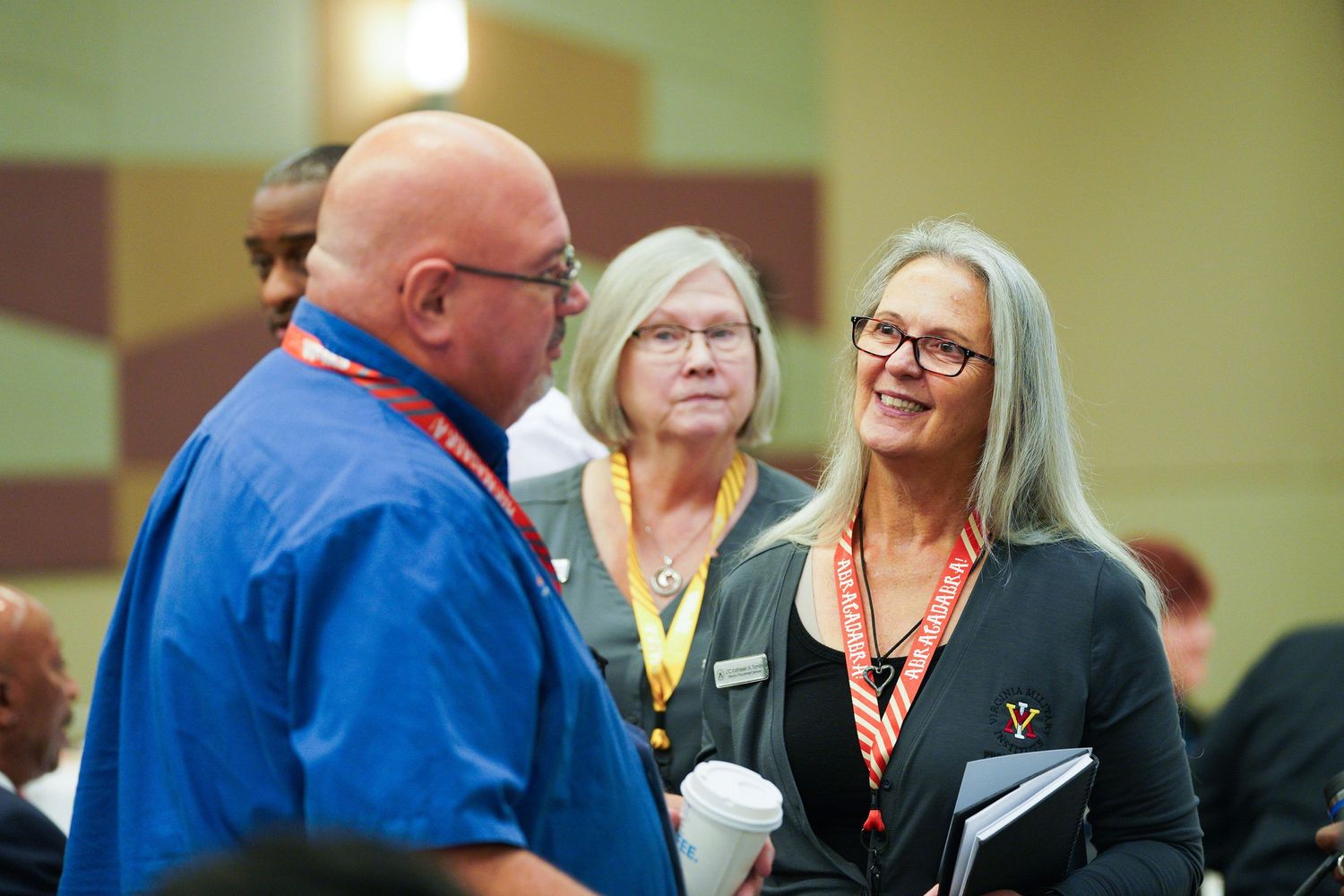 Event photography capturing a business gathering with attendees engrossed in discussion. Event photography