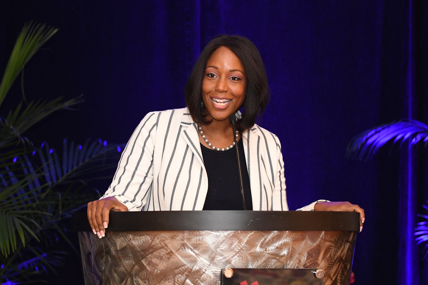 A professional woman expertly delivering a presentation to an attentive audience