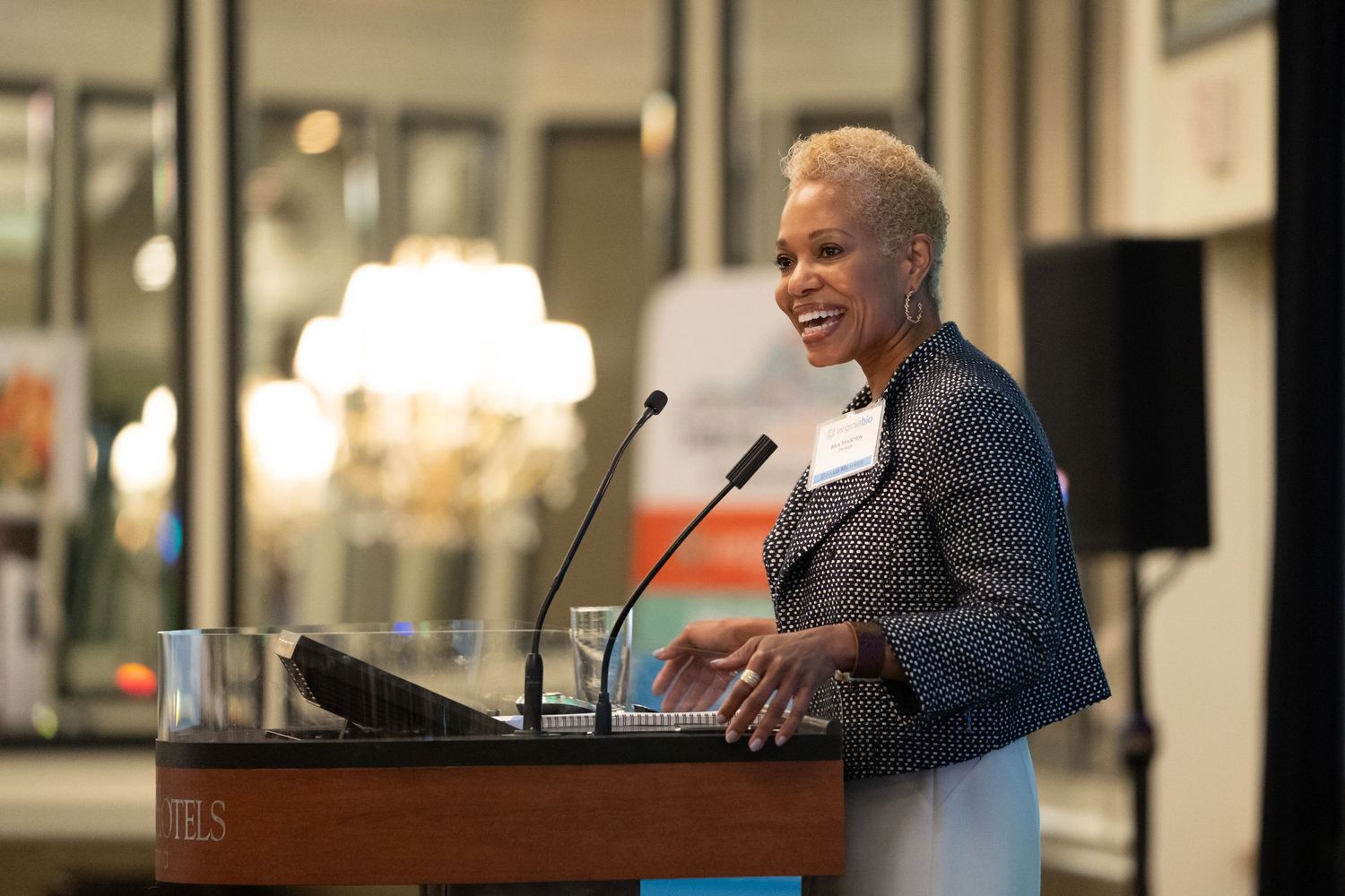 Dynamic image of a speaker commanding the stage at a professional conference, audience engaged and attentive