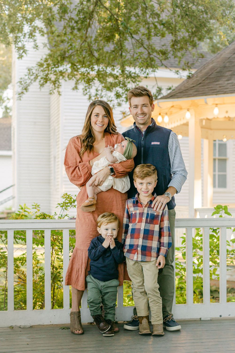 a family photo of mom, dad, two sons, and a baby girl