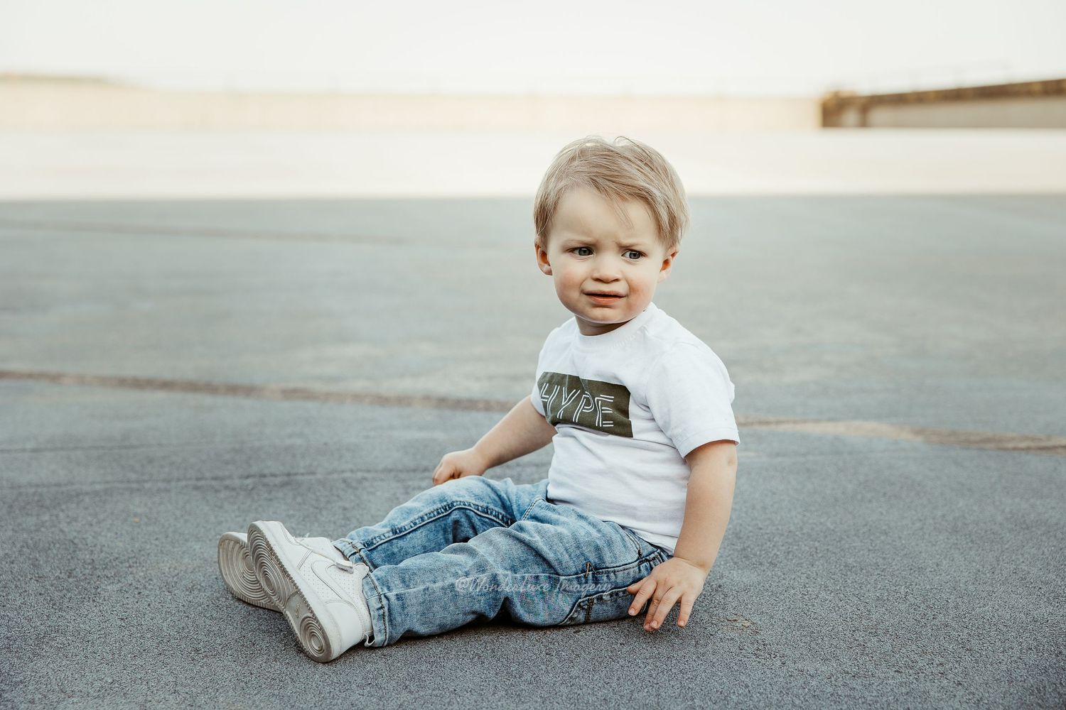 Cute toddler boy sitting on ground in parking garage clarksburg west virginia