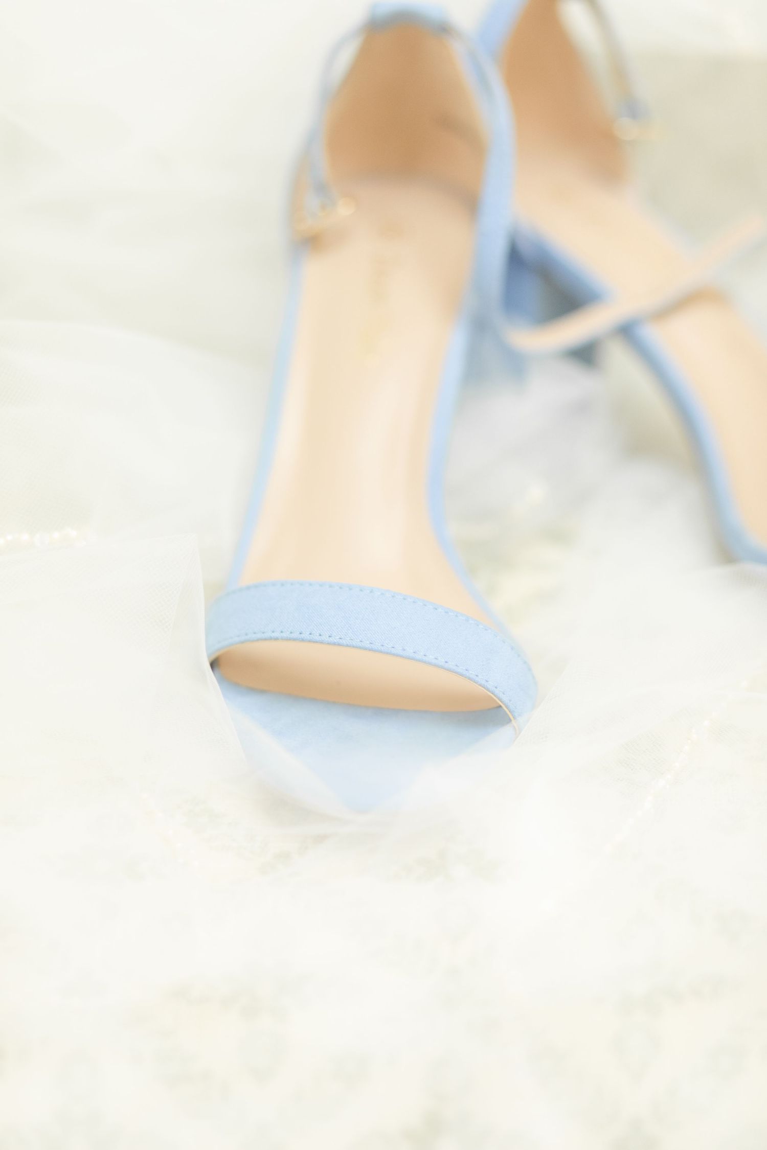 Light blue wedding heels with soft focus and dreamy lighting.