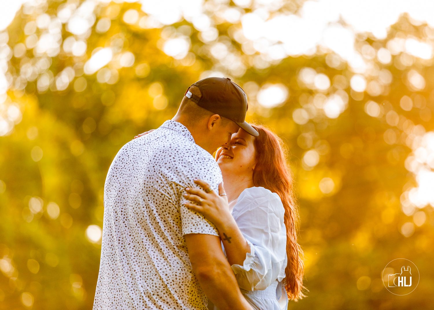 Romantic couple sharing tender moment in golden sunset light.
