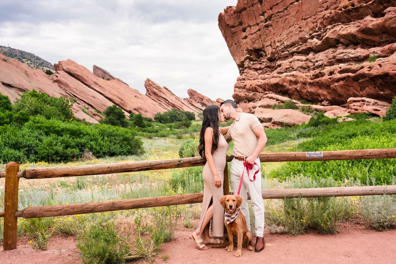 Couple posing with their dog at Red Rocks Park natural amphitheater.
