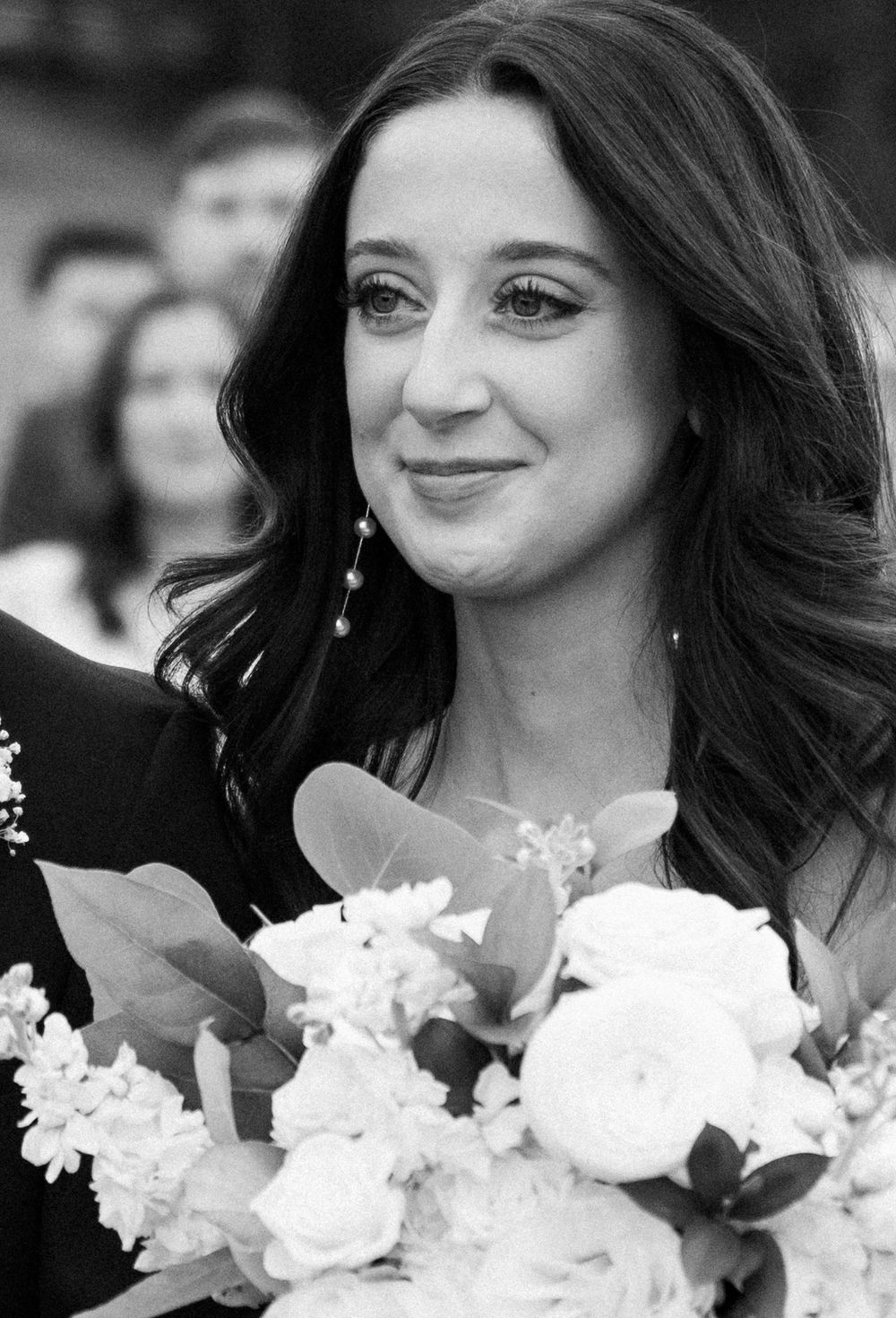 Black and white portraits of a woman holding a white floral bouquet.
