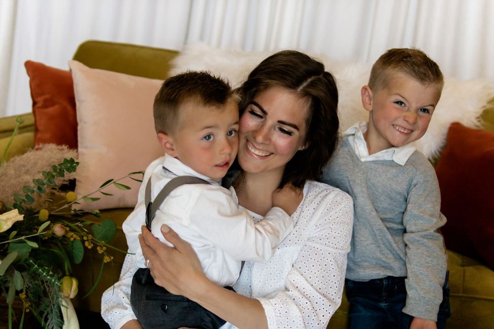 Mother and child sharing tender moment during indoor photo session.
