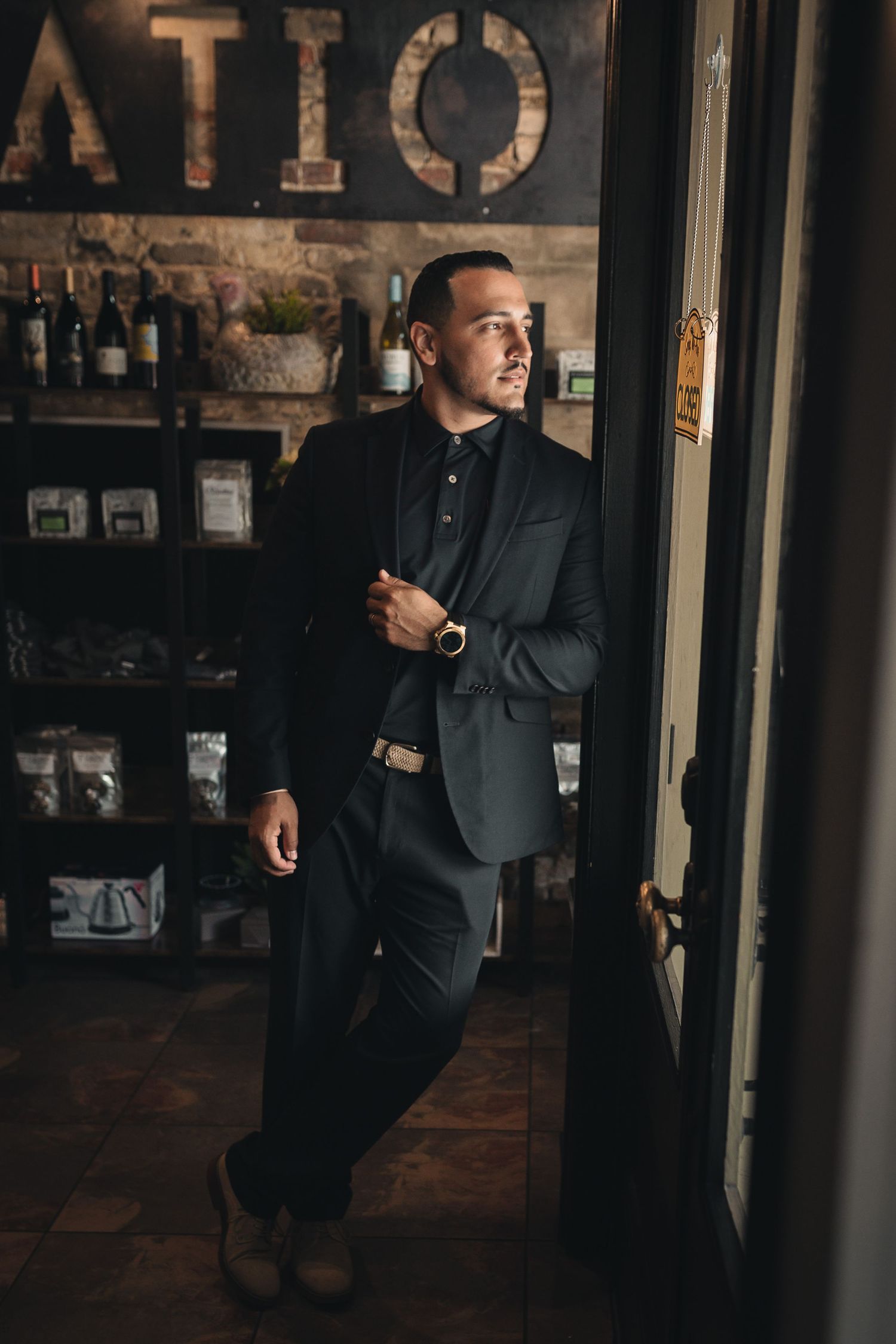 man looking out a window in a professional suit