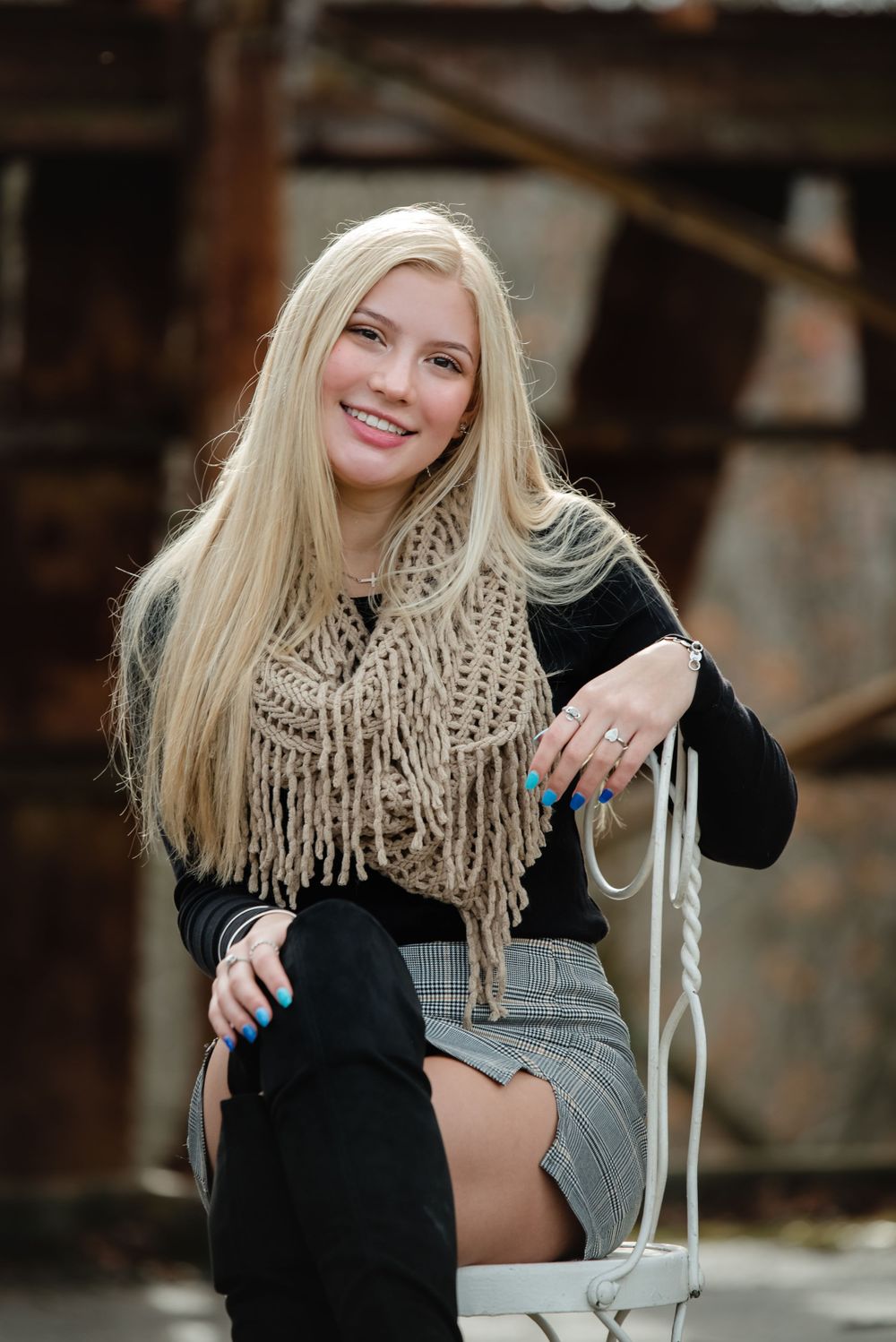 senior girl with chair in abandoned building