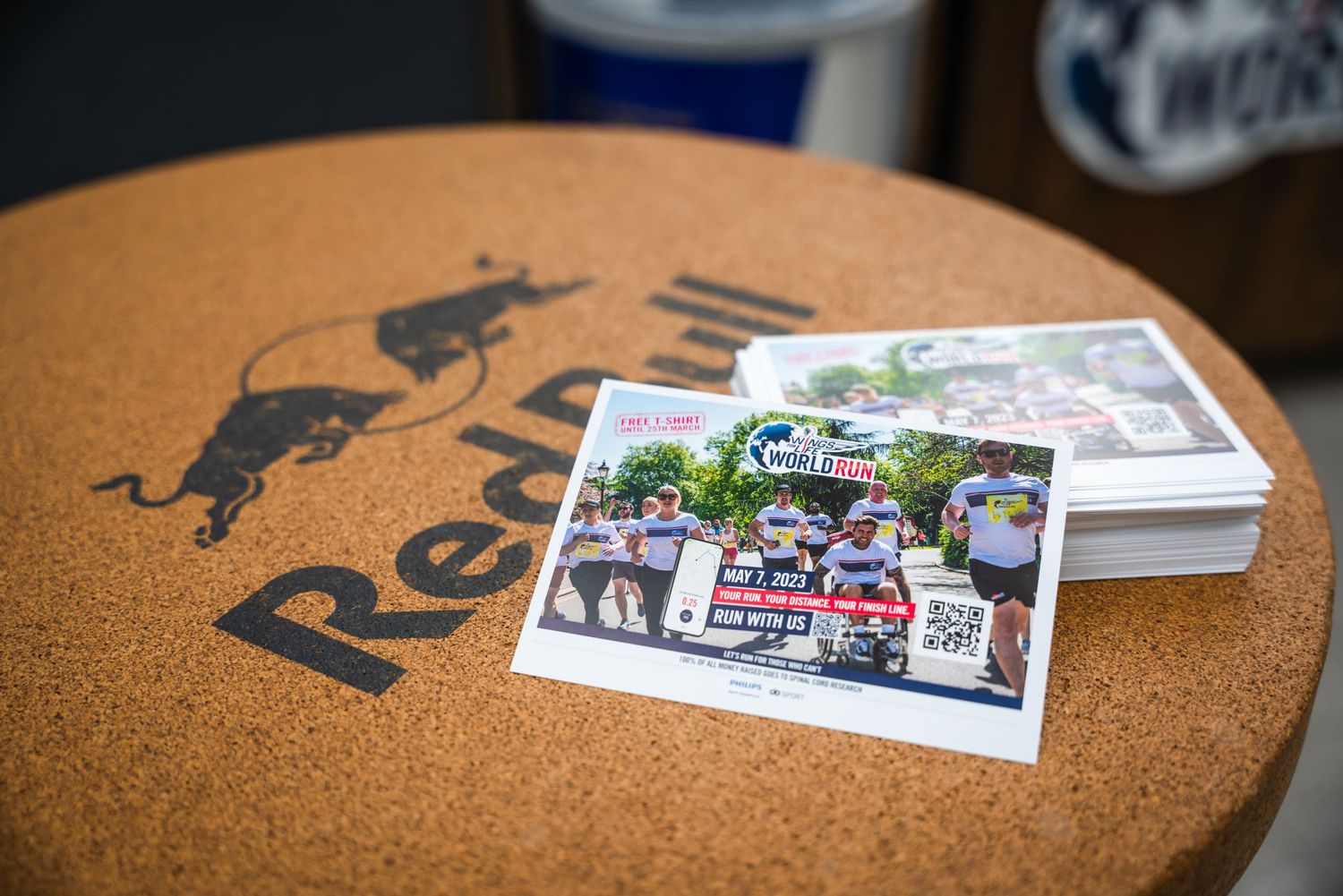 A cork surface with a silhouette logo and photographs displayed on top.