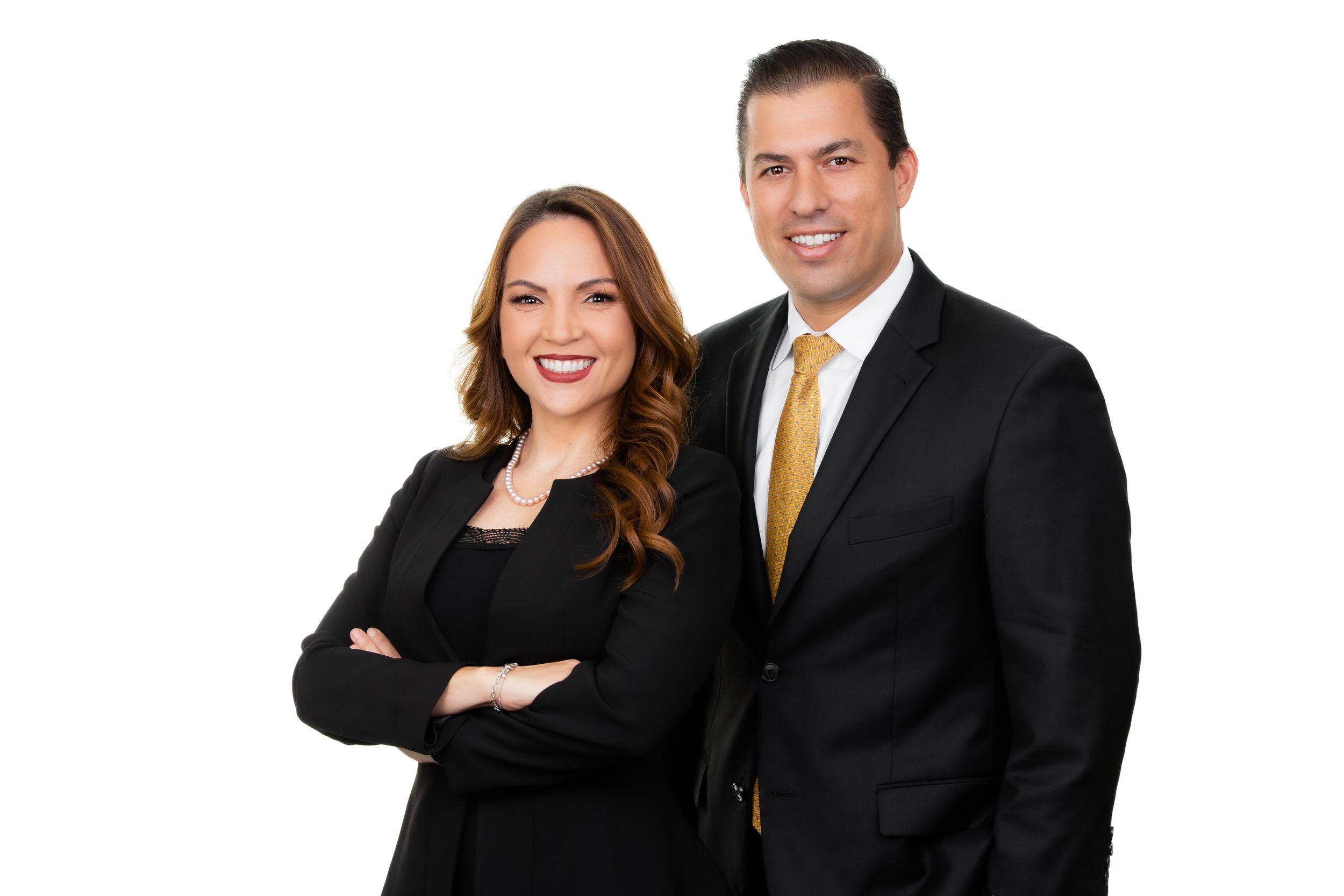 Two professionals in business attire pose together against white backdrop.