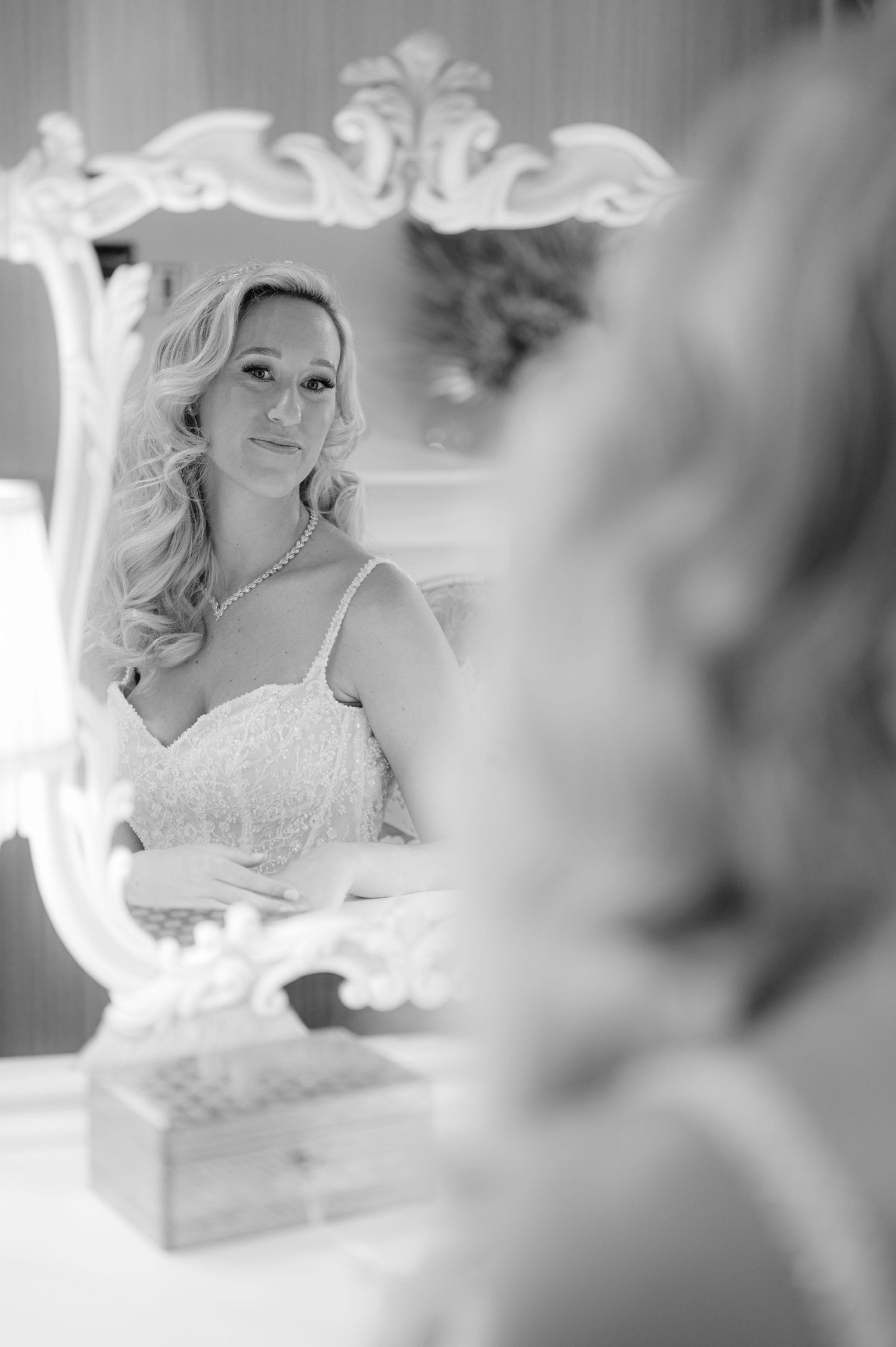Ornate vintage mirror reflection in black and white tones.