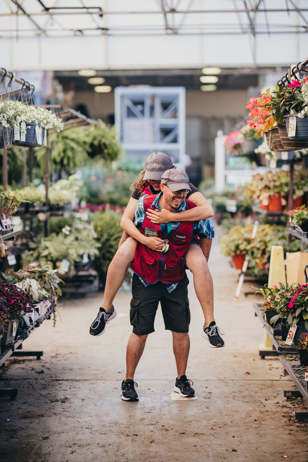 Lowes couple piggy back ride through aisles