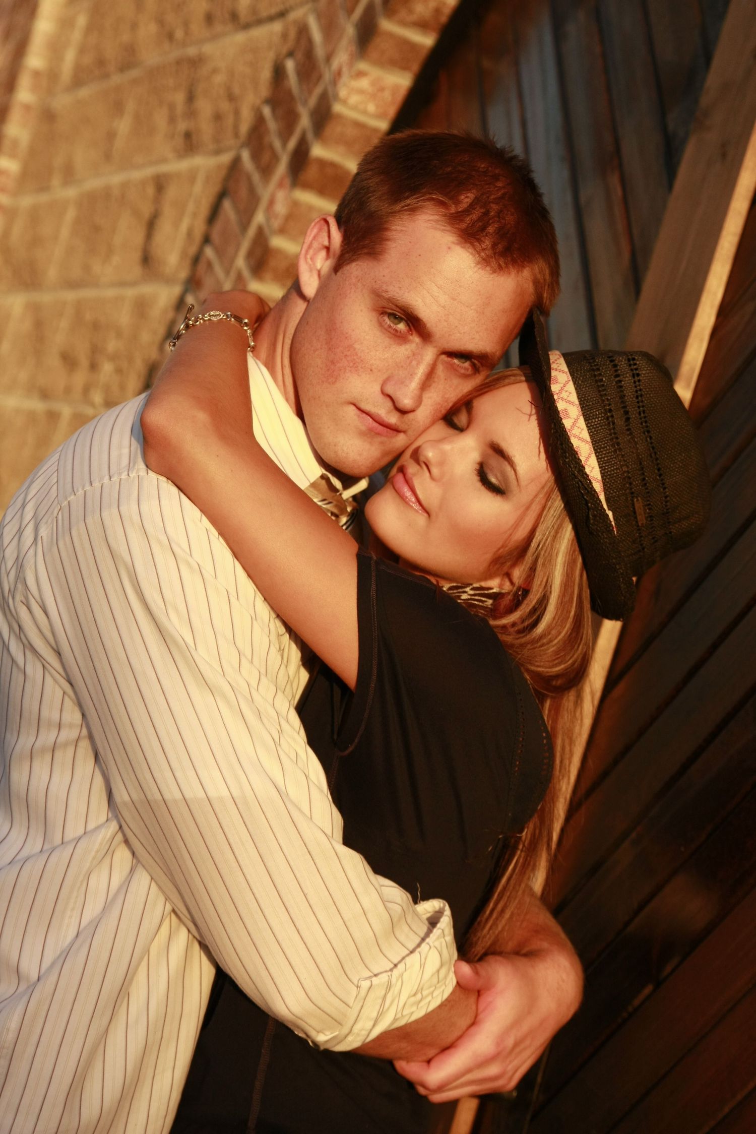 Romantic portrait series with dramatic lighting against a wooden background.