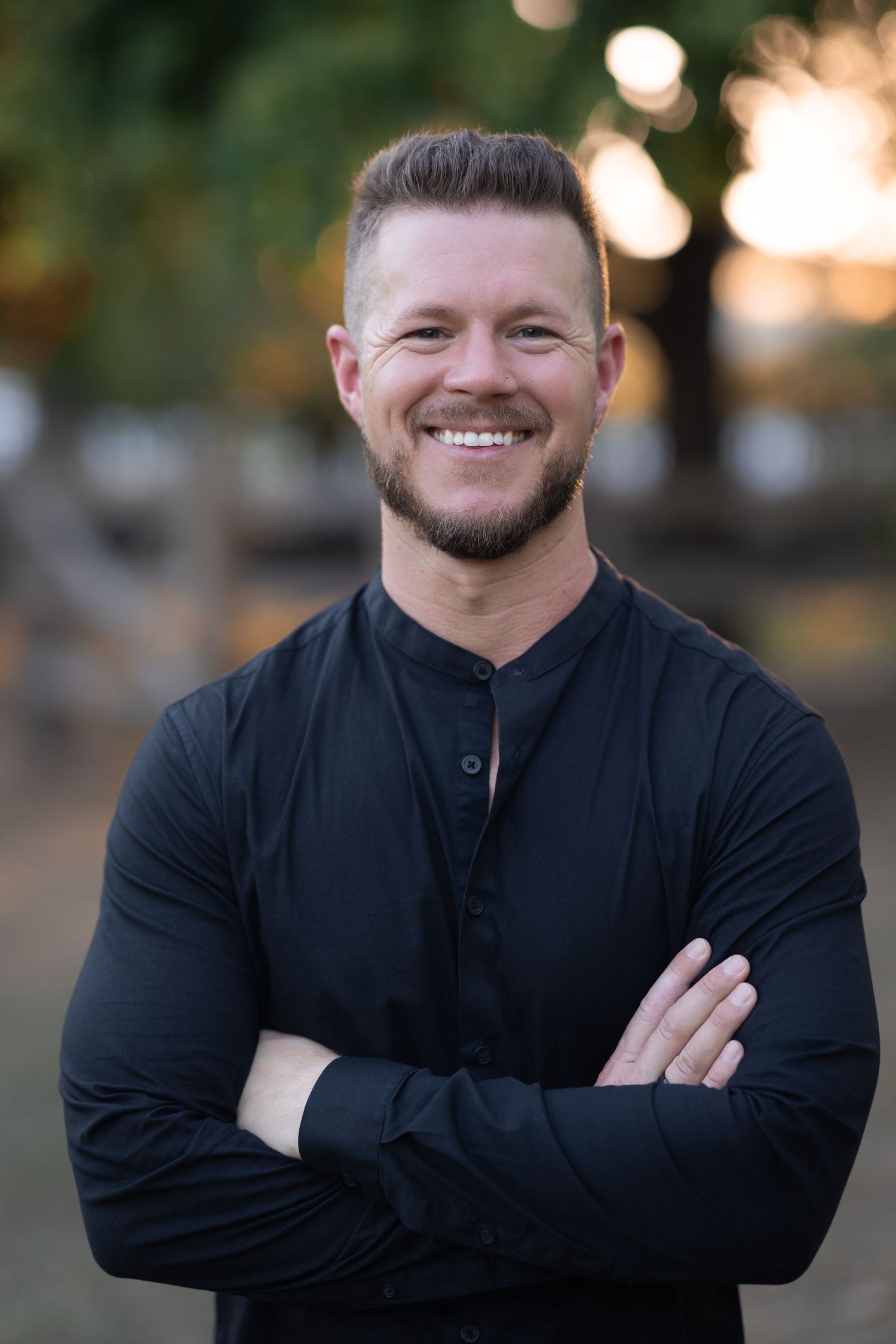 Professional headshot series of a person in black clothing against a blurred background.