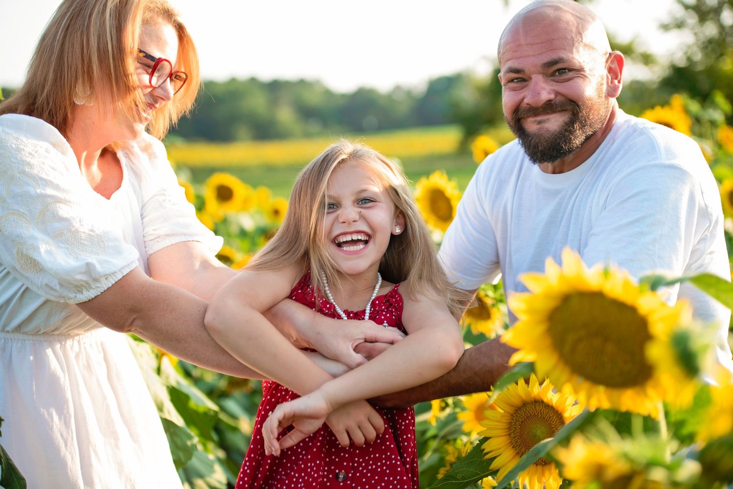 Joyful summer moment captured in a sunflower field during golden hour.