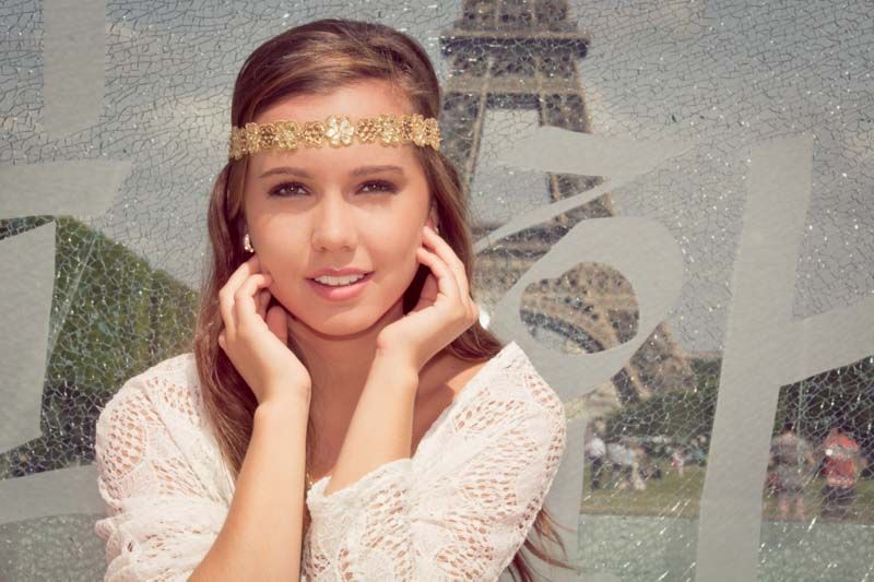 A solo female traveler captures a stunning photo in front of the Eiffel Tower, with a sense of adventure and exploration