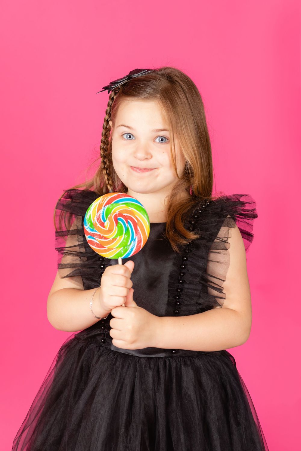 little girl in black dress sitting on teal stool on savage tulip pink backdrop in studio clayton new jersey gloucester