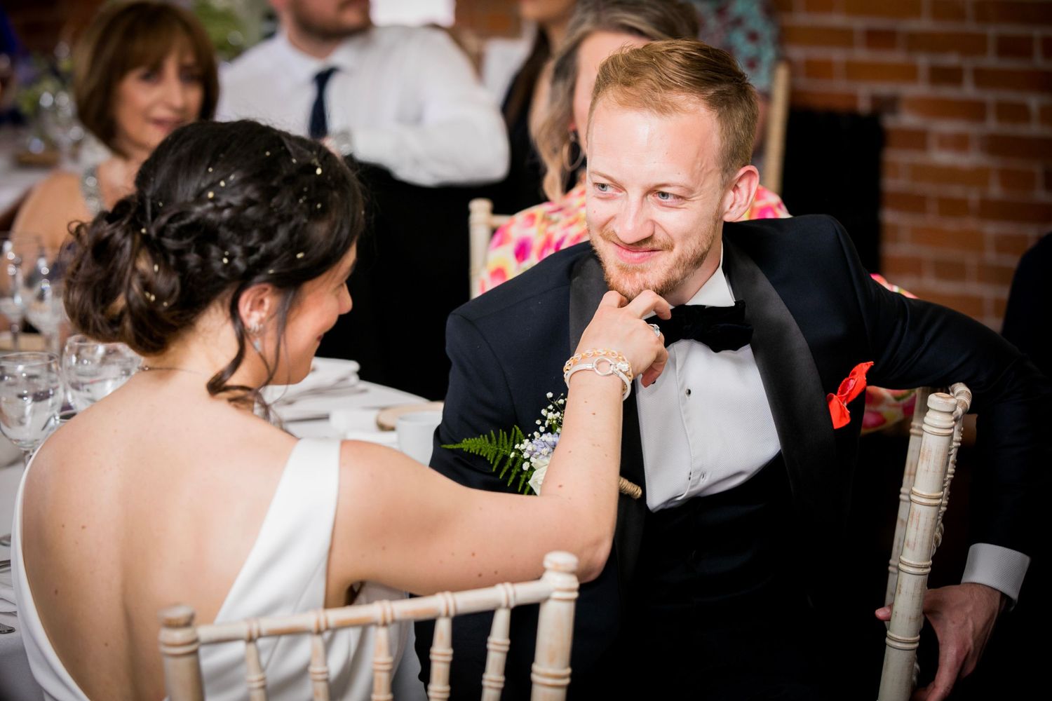 Emotional reactions during wedding speeches at an indoor reception.