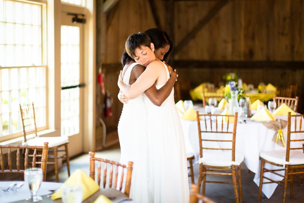 Quonquont farm wedding couple embrace after ceremony