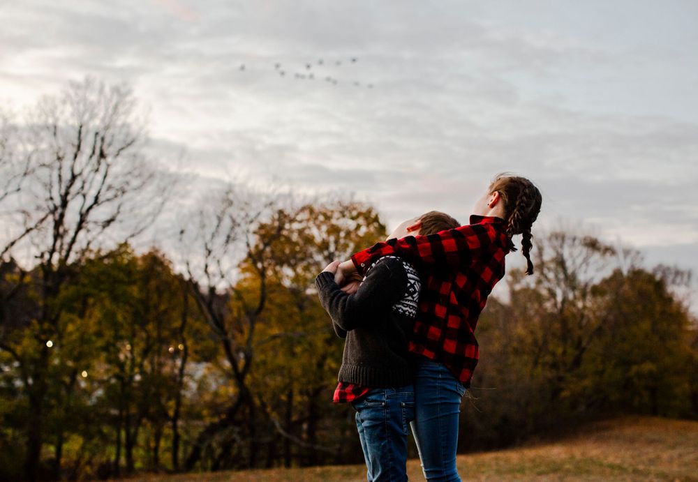 Siblings embrace during family photo session in Lexington MA