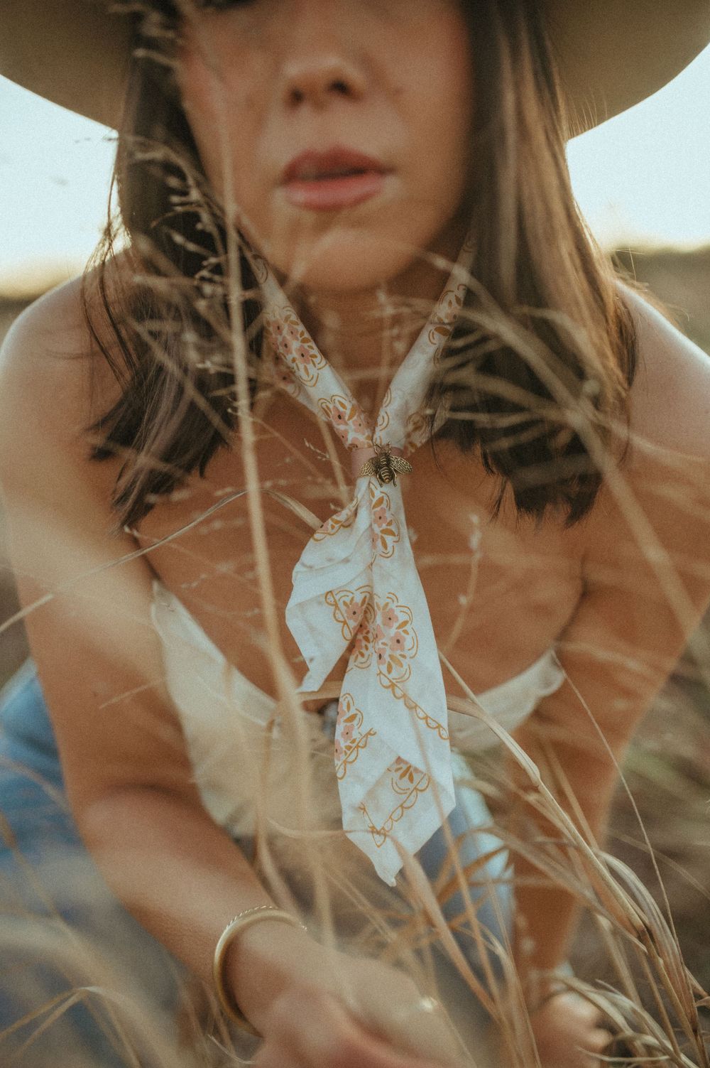 Artistic close-up shot through grass featuring delicate lace details.