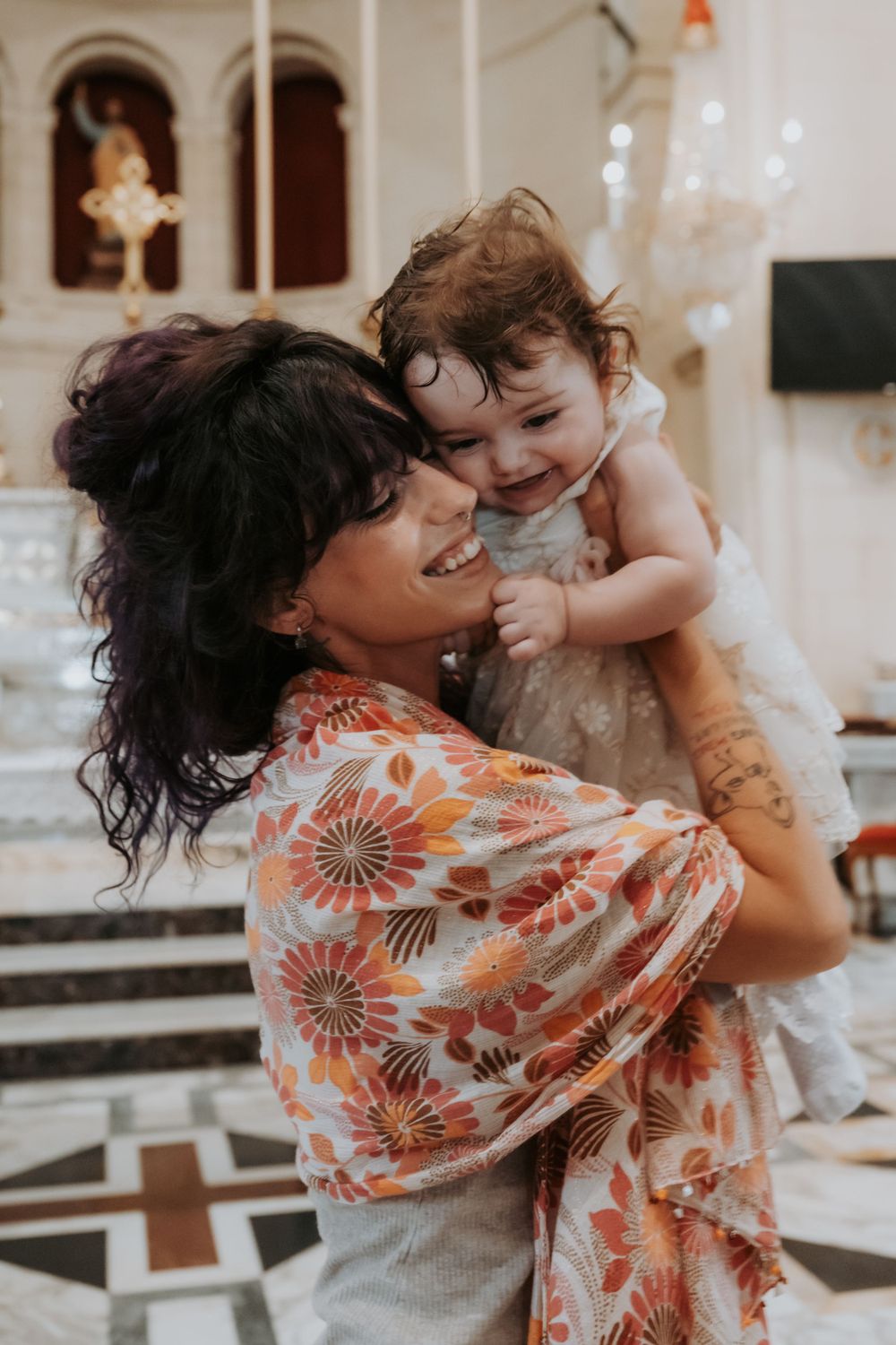 A series of candid moments showing affectionate interaction with a baby in a floral dress.