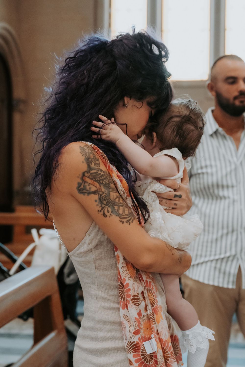 Sequence of loving moments between parent and baby during a family gathering.