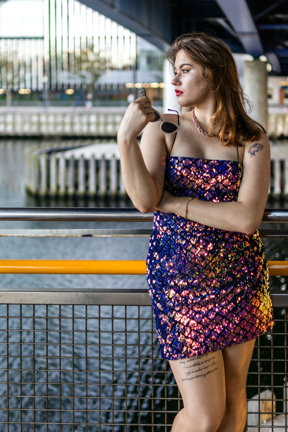 Gorgeous model, Beata, photographed in a stunning purple fashion dress by Keith Malda Photography biting sunglasses