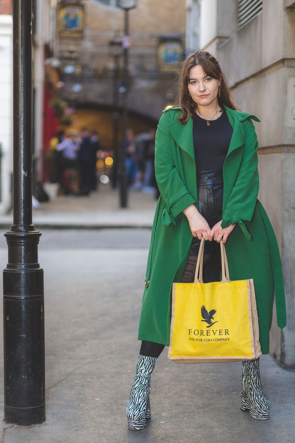 Gorgeous model Beata posing in London wearing green and black and holding a yellow bag