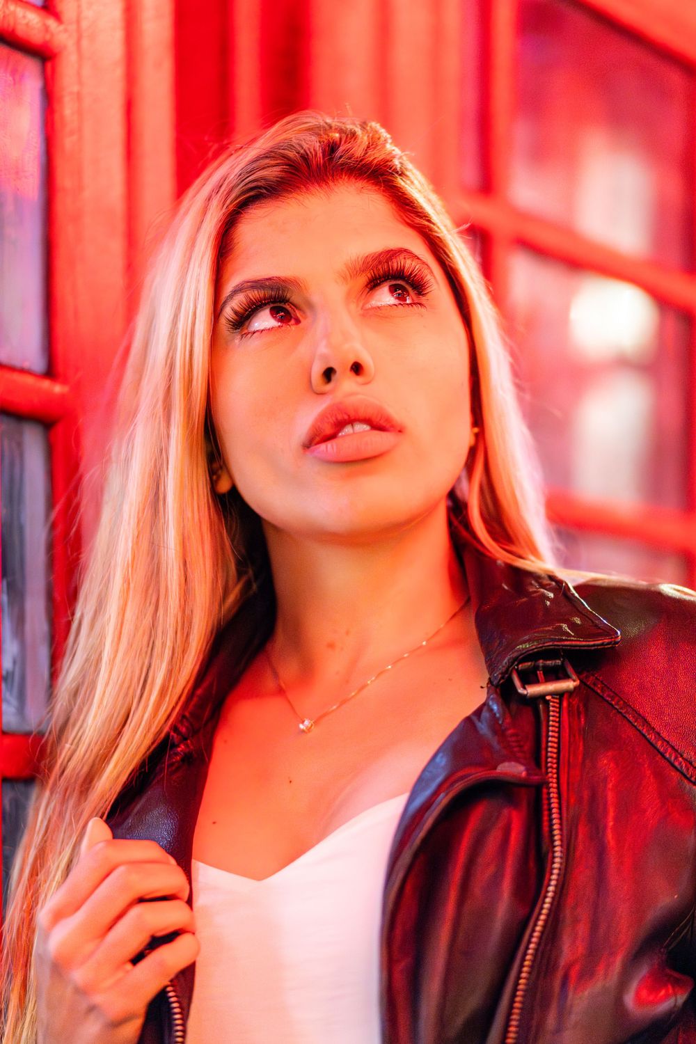 Beautiful model, Beatriz Sonnewend posing against a red London phone box