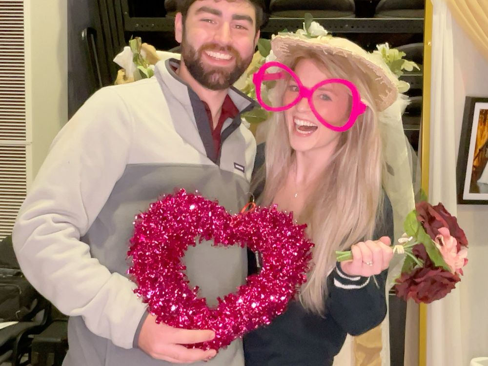 Happy couple enjoying the photo booth at the 2024 Twin Lakes Radio Bridal Expo in Mountain Home, AR