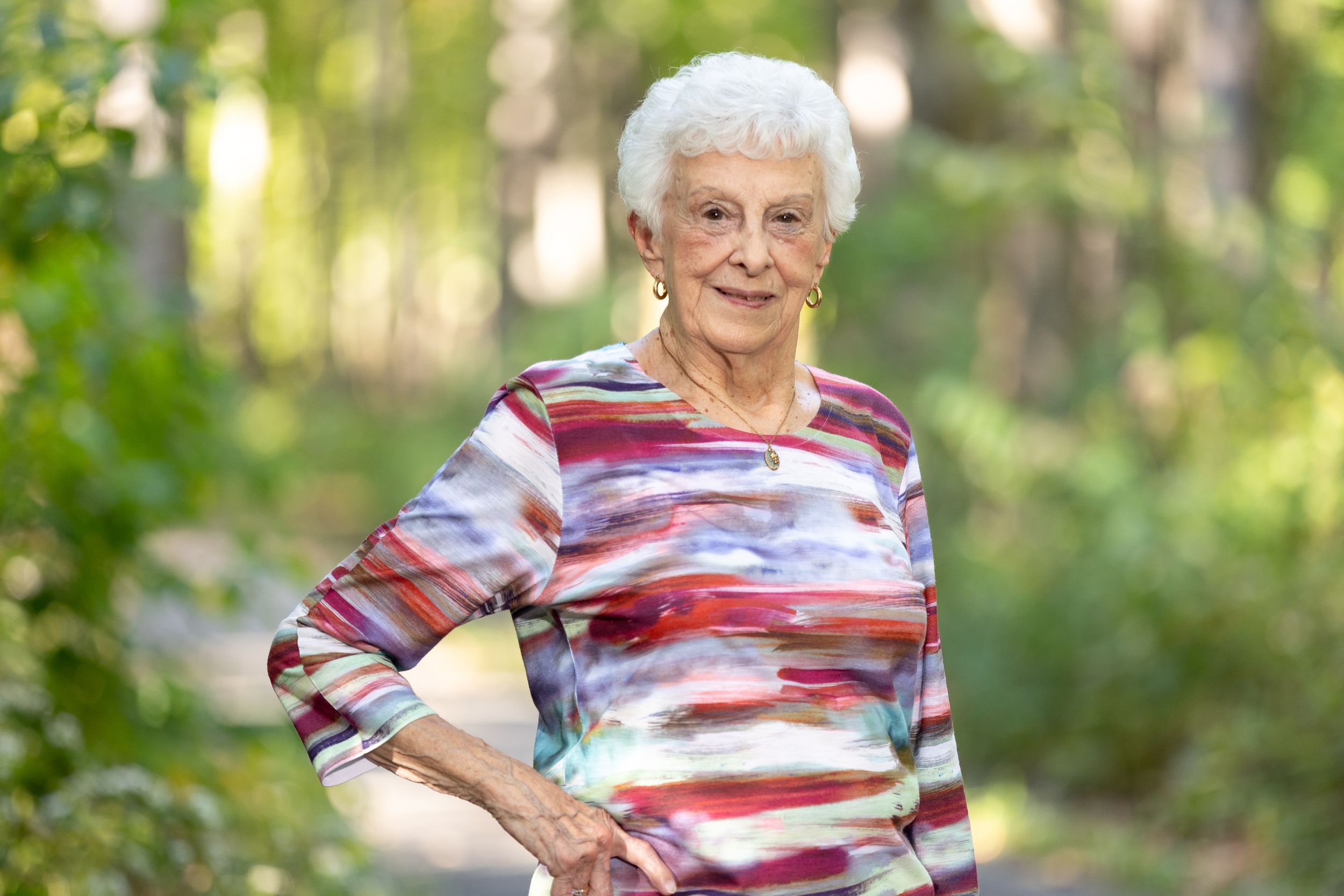 Elderly woman looking pretty on a trail through Walnut State Park.