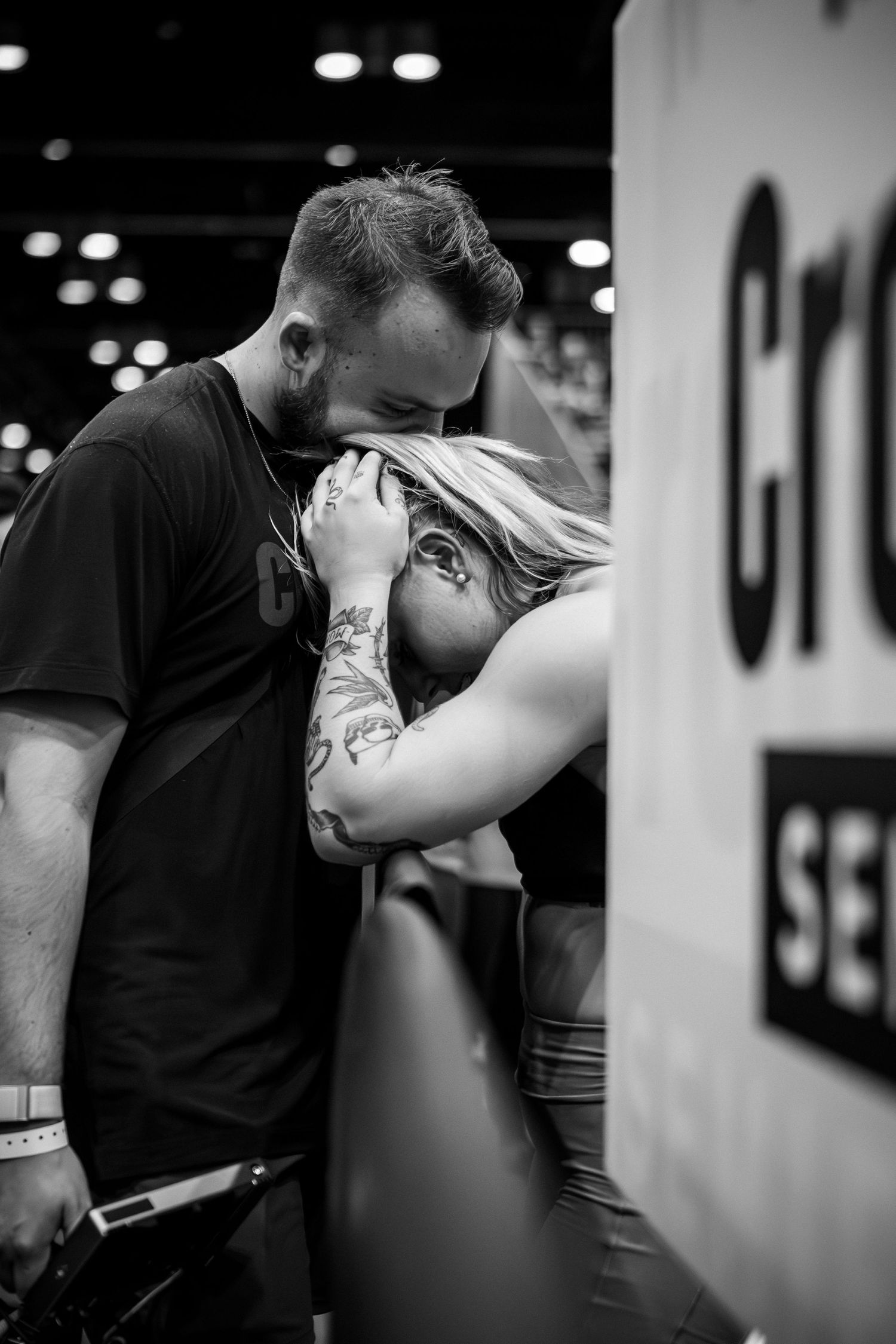 Emotional moment between two athletes during competition break.