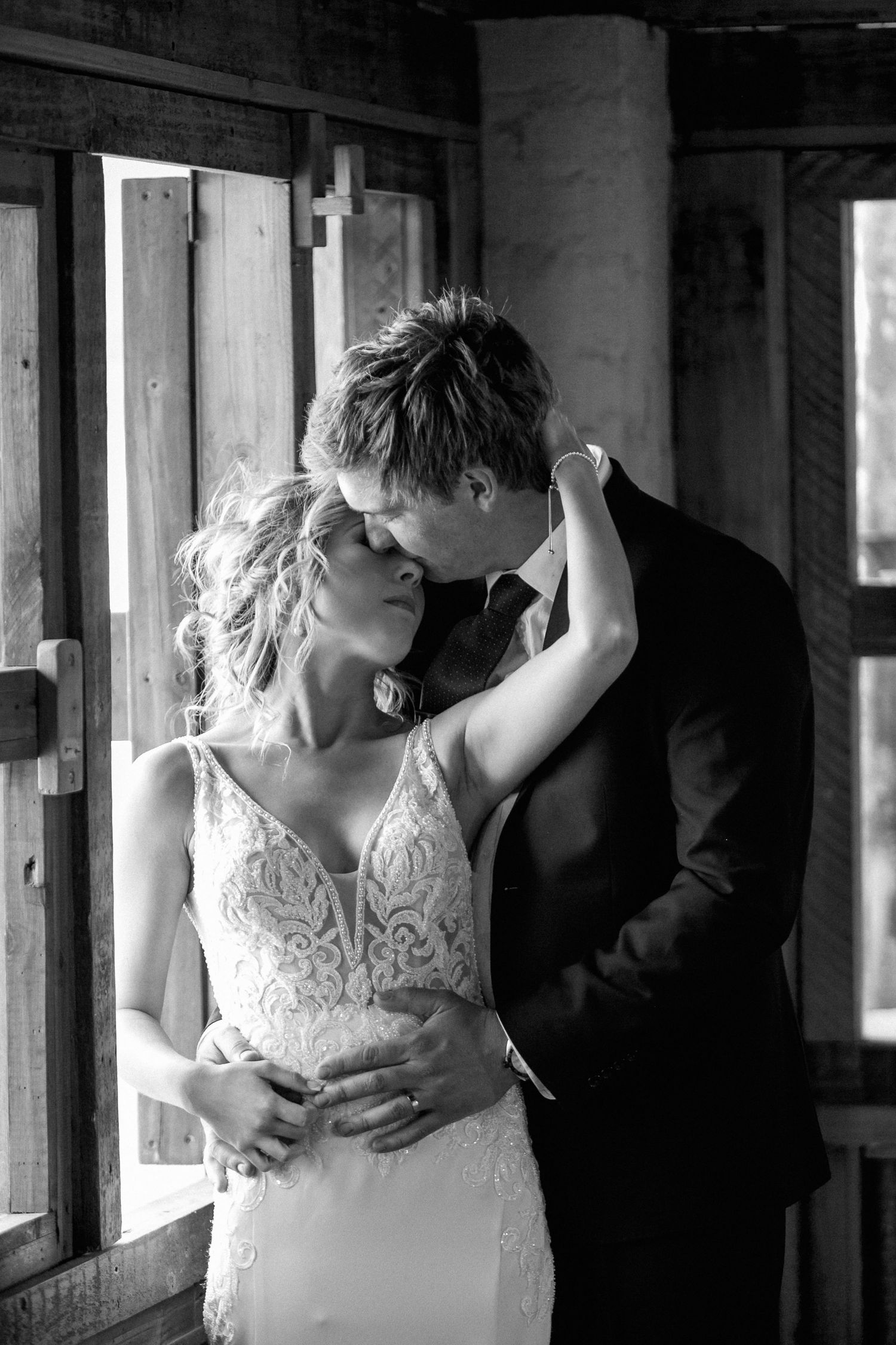 A bride and groom embrace on their rainy wedding day iin Memel, South Africa.