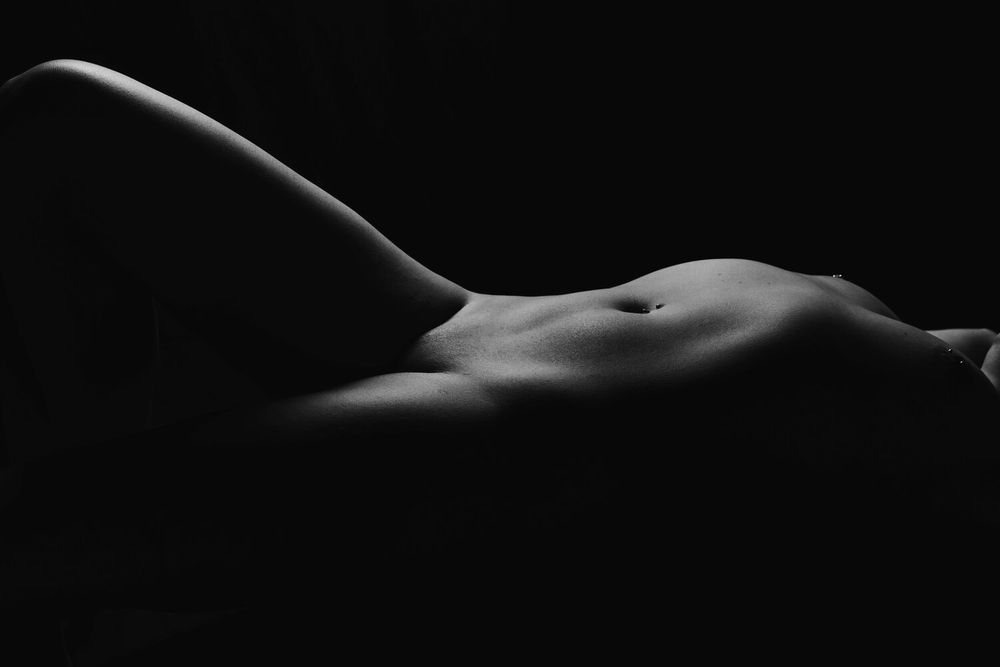 Dramatic low key photograph of curved silhouette forms in black and white.