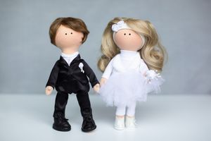 Handmade bride and groom wedding dolls dressed in black suit and white tulle dress.