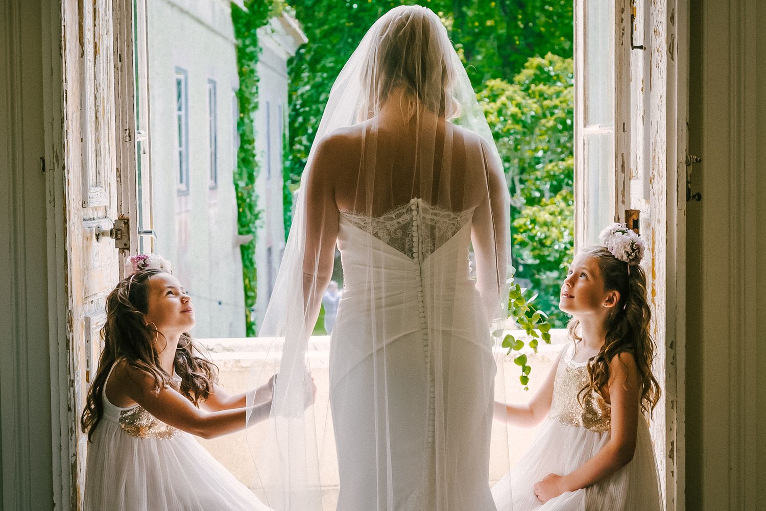 Bride and girls holding hands
