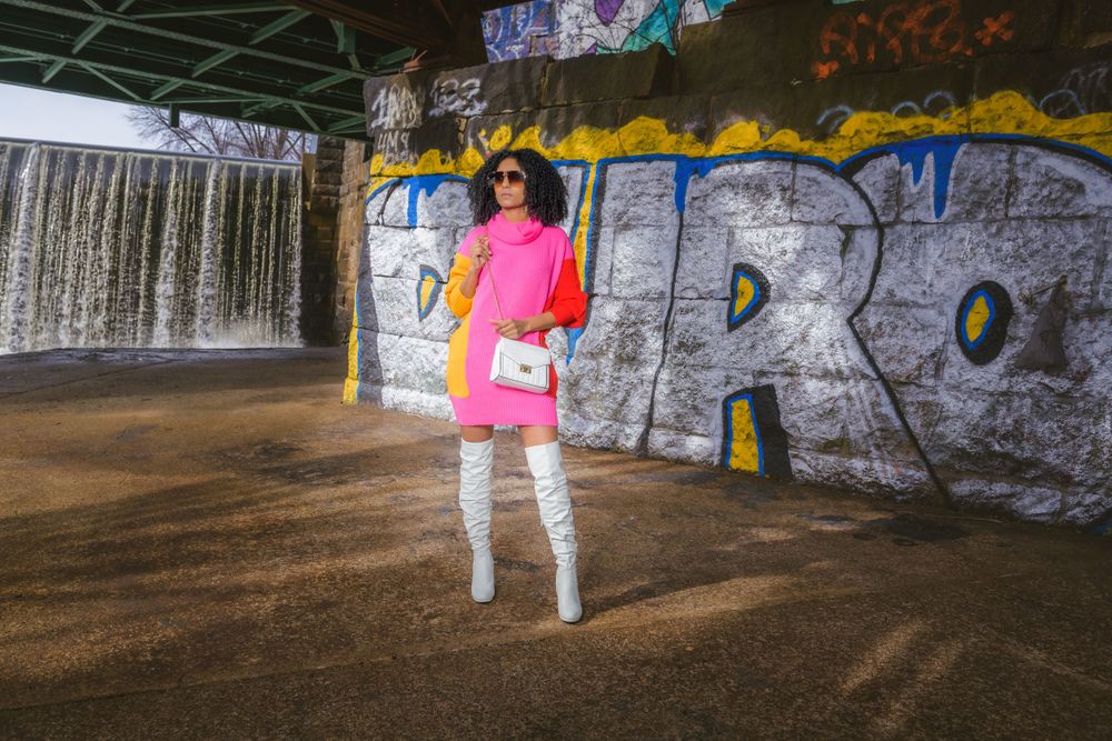 A fashion photoshoot featuring bold colors against urban graffiti and street art.