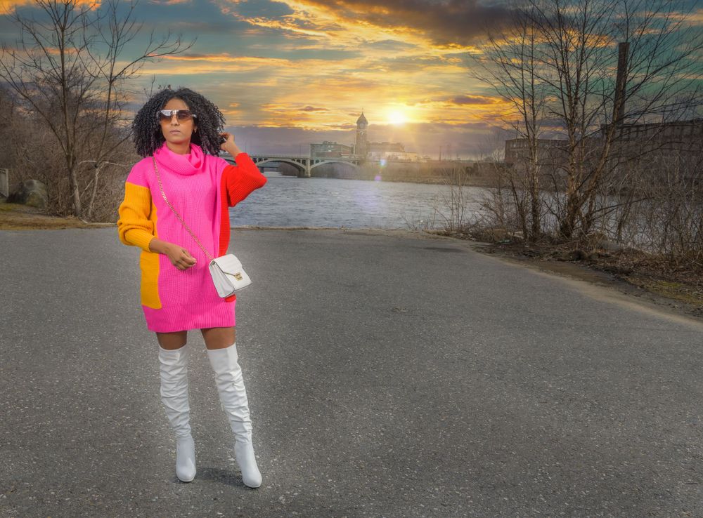 A colorful fashion ensemble photographed during golden hour on an empty street.