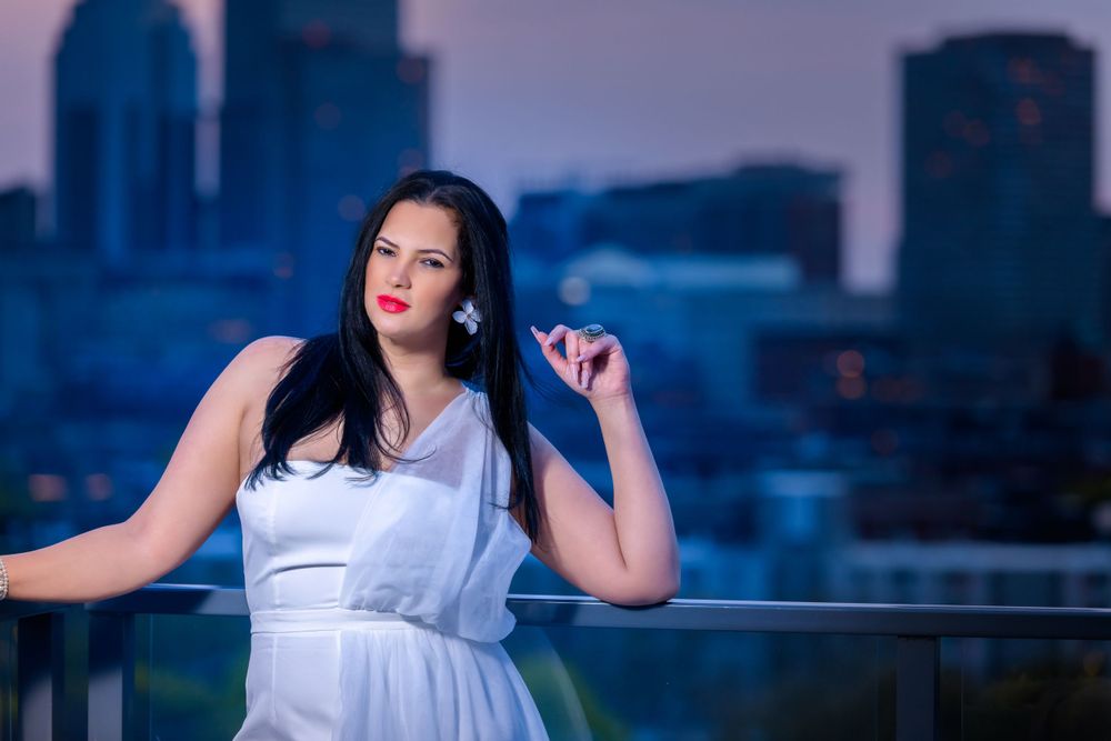 Ethereal white dress against city skyline during blue hour.