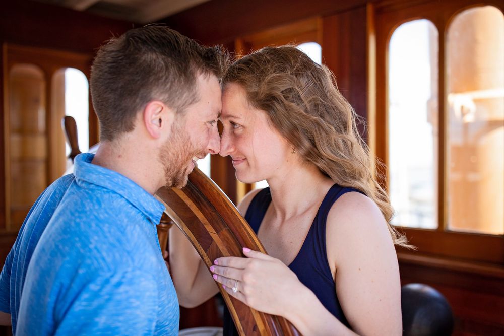 Couple sharing an intimate moment in a rustic indoor setting with natural lighting.