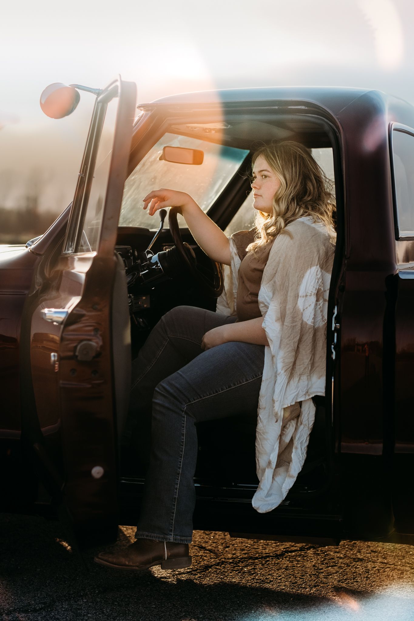 High School senior sitting in a pickup truck during a senior photography session in St. Joseph, Missouri.