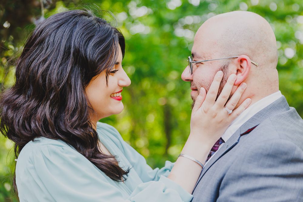 An intimate outdoor portrait of a couple sharing a tender moment.