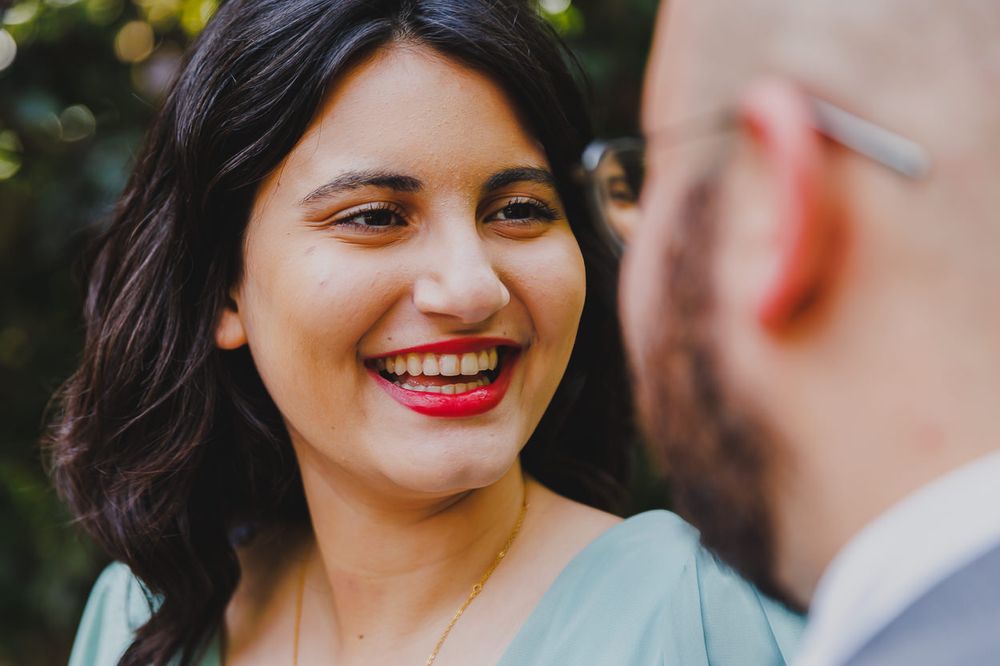 A close-up of a joyful moment shared between a couple in an outdoor setting.