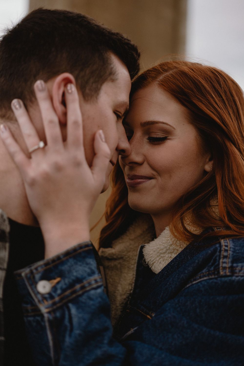 An intimate close-up portrait of a couple sharing a romantic moment.