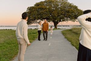 Family captured in a candid moment, walking on a scenic pathway by the water at Ramsgate dusk
